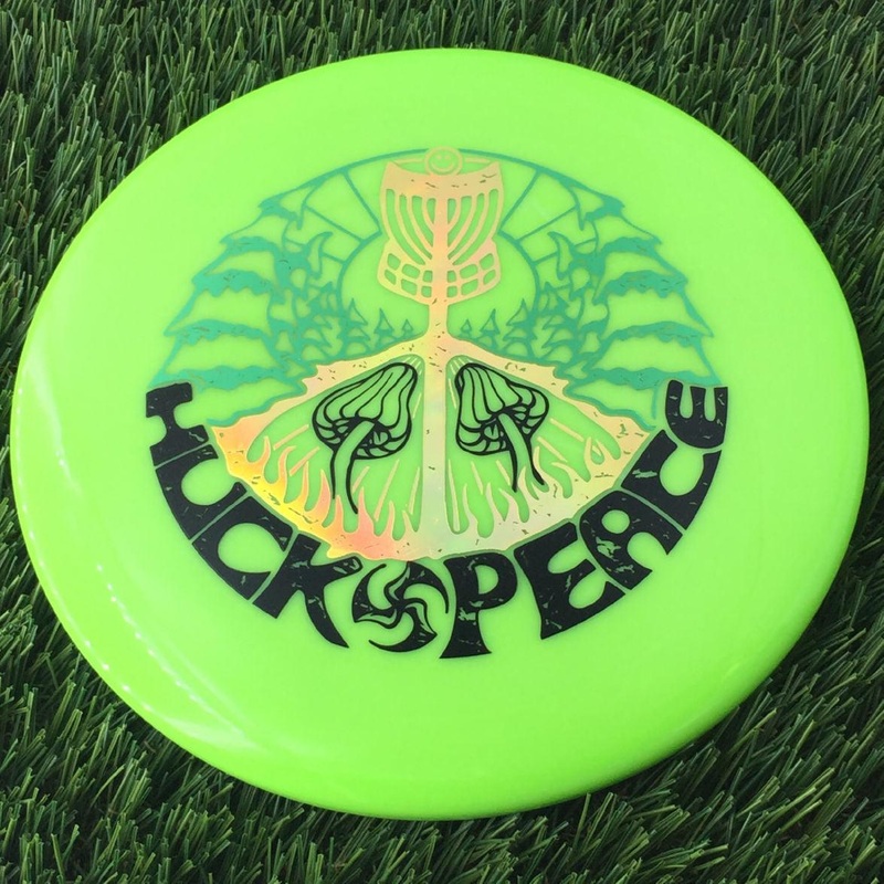 Discmania Soft Neo Spore with Huck Peace – Small TriFly in the Forest – Triple Foil Stamp – 159g – Translucent Muted Green